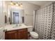 Bathroom featuring a single sink vanity, a toilet, and a shower/tub with gray shower curtain at 5110 Hyde Park Village Ln, North Charleston, SC 29405
