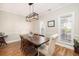 Elegant dining room with hardwood floors, stylish light fixture, and ample natural light, perfect for gatherings at 5110 Hyde Park Village Ln, North Charleston, SC 29405