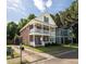 Charming brick home with double balconies and mature landscaping, offering classic curb appeal at 5110 Hyde Park Village Ln, North Charleston, SC 29405