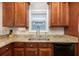Kitchen with wood cabinets, granite countertops, a stainless steel sink, and appliances at 5110 Hyde Park Village Ln, North Charleston, SC 29405