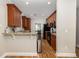 Bright kitchen with wood cabinets, granite countertops, stainless appliances, and wood floors at 5110 Hyde Park Village Ln, North Charleston, SC 29405