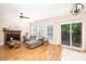 Comfortable living room with a fireplace, wood floors, and a sliding glass door to the outdoors at 5110 Hyde Park Village Ln, North Charleston, SC 29405