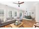 Bright living room featuring wood floors, a fireplace, a sectional sofa, and lots of natural light at 5110 Hyde Park Village Ln, North Charleston, SC 29405