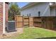 A side yard containing an AC unit, with a privacy fence and patch of green grass at 5110 Hyde Park Village Ln, North Charleston, SC 29405
