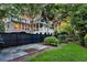 Home's back exterior features an enclosed porch, surrounded by lush greenery, offering a private backyard space at 512 Whilden St, Mount Pleasant, SC 29464