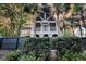 Back of the home with an enclosed porch, surrounded by palm trees, with a dark fence and yard at 512 Whilden St, Mount Pleasant, SC 29464