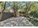 Spacious backyard with a stone patio, trees, and privacy fence at 512 Whilden St, Mount Pleasant, SC 29464