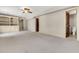 A flexible basement area features neutral carpet, ceiling fan, built-in storage, and access to a bathroom, perfect for customization at 512 Whilden St, Mount Pleasant, SC 29464