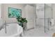 Bathroom features soaking tub, glass shower, marble floors, and built in storage at 512 Whilden St, Mount Pleasant, SC 29464