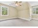 Sloped ceiling bedroom with two windows, light walls, and neutral carpet at 512 Whilden St, Mount Pleasant, SC 29464