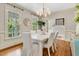 Elegant dining room boasts large windows, stylish lighting, and seating for six at 512 Whilden St, Mount Pleasant, SC 29464