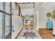 Inviting entryway featuring hardwood floors, a staircase, and a glimpse into the open-concept living area at 512 Whilden St, Mount Pleasant, SC 29464