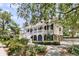 Beautiful two-story home with white porches, lush landscaping, and driveway at 512 Whilden St, Mount Pleasant, SC 29464