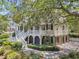 Charming home with a white staircase, inviting porch, black shutters, and mature landscaping creating a picturesque scene at 512 Whilden St, Mount Pleasant, SC 29464