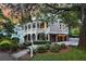 Elegant home with a large porch, ground level garages and manicured greenery surrounding the property at 512 Whilden St, Mount Pleasant, SC 29464