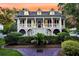 Charming two-story home with a inviting front porch, manicured landscaping and a brick path at 512 Whilden St, Mount Pleasant, SC 29464