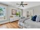 Spacious main bedroom featuring hardwood floors, bright windows, and closet with French doors at 512 Whilden St, Mount Pleasant, SC 29464