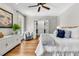 Spacious main bedroom with hardwood floors, ceiling fan and decorative art pieces at 512 Whilden St, Mount Pleasant, SC 29464