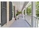 Inviting veranda with white columns and black shutters, providing a picturesque outdoor area for relaxation and enjoyment at 512 Whilden St, Mount Pleasant, SC 29464