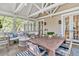 Comfortable outdoor seating and dining area on a covered porch, perfect for entertaining or enjoying the outdoors at 512 Whilden St, Mount Pleasant, SC 29464