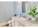 Stylish powder room featuring patterned wallpaper, a marble countertop, and a decorative mirror with natural light at 512 Whilden St, Mount Pleasant, SC 29464
