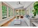 Bright sun room with large windows, hardwood floors, vaulted ceiling, and stylish, comfortable furnishings at 512 Whilden St, Mount Pleasant, SC 29464
