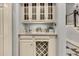 Elegant wet bar with marble countertop, wine rack, glass cabinets, and stainless-steel faucet—perfect for entertaining at 512 Whilden St, Mount Pleasant, SC 29464