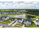 Aerial view of a new home community featuring homes with well-manicured lawns, a pond, and surrounded by trees at 513 Richfield Way, Summerville, SC 29486
