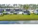 Aerial view of large, well-maintained backyards with green lawns and screened-in patios bordering a pond at 513 Richfield Way, Summerville, SC 29486