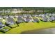 Aerial view of well-maintained backyards with green lawns and black fences with the community in the background at 513 Richfield Way, Summerville, SC 29486