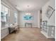 Bright dining room featuring a window, chandelier, modern art, bench, and wood flooring at 513 Richfield Way, Summerville, SC 29486