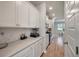 Kitchen featuring white cabinets, light countertops, stainless steel appliances, and light colored wood floors at 513 Richfield Way, Summerville, SC 29486