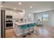 Kitchen with stainless steel appliances, white cabinets, bar stool seating and an adjacent dining area with lake view at 513 Richfield Way, Summerville, SC 29486