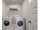 Functional laundry room equipped with a washer, dryer, and shelving for organized storage at 513 Richfield Way, Summerville, SC 29486