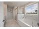 Luxurious main bathroom with a soaking tub, glass-enclosed shower, and marble-like tile at 513 Richfield Way, Summerville, SC 29486