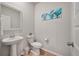 Stylish powder room with a pedestal sink, decorative mirror, and modern accents at 513 Richfield Way, Summerville, SC 29486