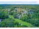 Aerial view of a residential area surrounded by mature trees and featuring well-maintained lawns and streets at 5406 E Crosland Ct, North Charleston, SC 29420
