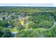 Aerial view of a scenic neighborhood with lush trees, well-kept lawns, and a peaceful residential setting at 5406 E Crosland Ct, North Charleston, SC 29420