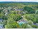 Aerial view of a residential community with lush greenery, mature trees, and a neighborhood swimming pool at 5406 E Crosland Ct, North Charleston, SC 29420