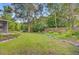 Expansive backyard with mature trees, lush lawn, and meticulously maintained landscaping at 5406 E Crosland Ct, North Charleston, SC 29420