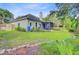 Spacious backyard showcasing a garden, mature trees, and a well-manicured lawn at 5406 E Crosland Ct, North Charleston, SC 29420