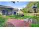 Scenic backyard featuring a lovely garden, brick path, and cozy seating area at 5406 E Crosland Ct, North Charleston, SC 29420