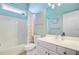 Bright bathroom features a shower-tub combo and a white vanity with ample storage and counter space at 5406 E Crosland Ct, North Charleston, SC 29420