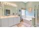 Bathroom featuring dual sink vanity, soaking tub, and white cabinets at 5406 E Crosland Ct, North Charleston, SC 29420
