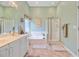 Well-lit bathroom featuring a soaking tub, a glass shower, and a double vanity with abundant counter space at 5406 E Crosland Ct, North Charleston, SC 29420