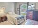 Inviting bedroom with a double bed, a window overlooking a view, and warm lighting at 5406 E Crosland Ct, North Charleston, SC 29420