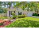 Landscaped home exterior featuring a well-maintained lawn, manicured flowerbeds, and an attached garage at 5406 E Crosland Ct, North Charleston, SC 29420