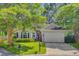 Inviting home exterior with lush trees, green lawn, and tidy landscaping at 5406 E Crosland Ct, North Charleston, SC 29420