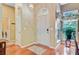 Welcoming home entryway with hardwood floors and natural light streaming through side window at 5406 E Crosland Ct, North Charleston, SC 29420