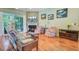 Bright living room features hardwood floors, fireplace, and access to a screened porch at 5406 E Crosland Ct, North Charleston, SC 29420